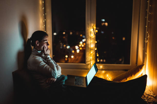 istock Woman sitting at home and using laptop during home isolation 1250343668