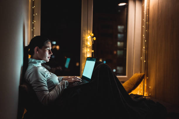 istock Woman sitting at home and using laptop during home isolation 1250344883