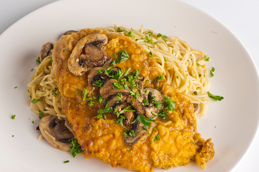 Chicken Marsala. Chicken breast breaded, fried topped with mushroom and Marsala wine sauce then served with angel hair pasta and dressed in olive oil. Classic Italian entree favorite.