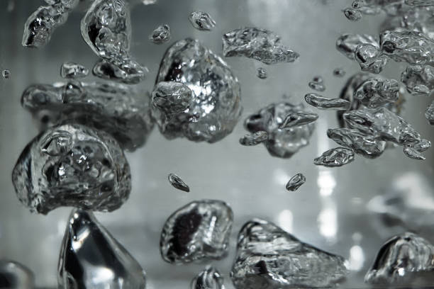 Drops and bubbles of mercury in water. Dangerous chemical element, the scientific experience. Drops and bubbles of mercury in water close-up. Dangerous chemical element, the scientific experience.  Defocused image, motion blur periodic table photos stock pictures, royalty-free photos & images
