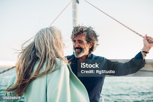istock Mature man and his wife enjoying sailing with their yacht 1250348419