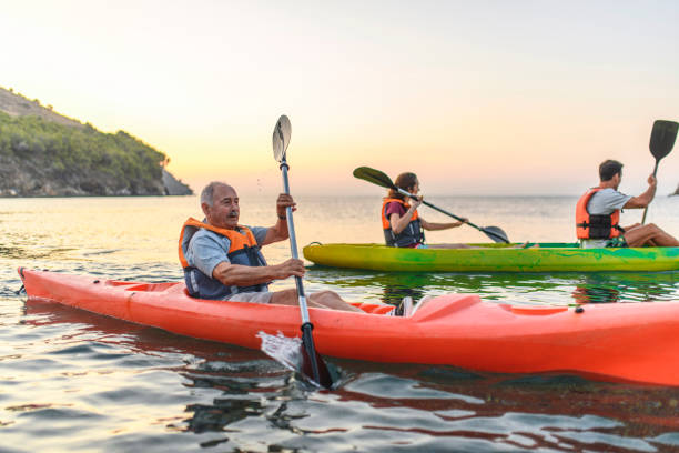 istock Senior Spanish Kayaker Exercising with Friends at Dawn 1250348484