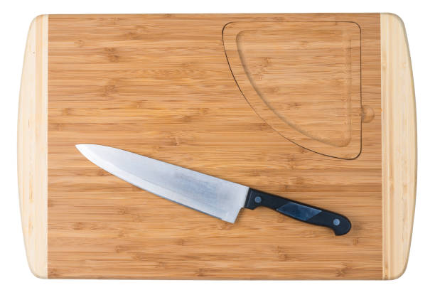 istock Wooden cutting board and sharp knife for the cook on a white background is insulated 1250348832