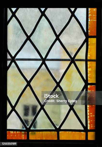 France View Through An Acient Window Stock Photo - Download Image Now - Stained Glass, Residential Building, Window