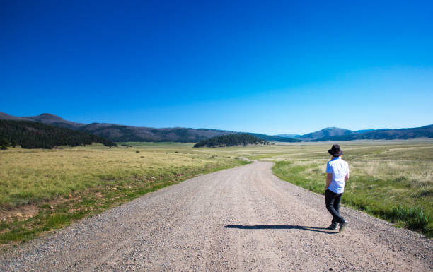 Man Walking Alone in Valles Caldera Wilderness, New Mexico Man Walking Alone in Valles Caldera Wilderness, New Mexico los alamos new mexico stock pictures, royalty-free photos & images