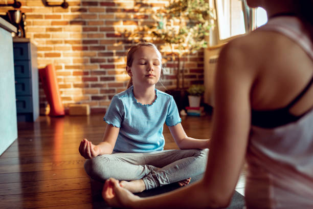 istock Mother and Daughter doing Yoga 1250357120