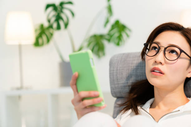 istock asian woman to see a smart phone,think, 1250360565