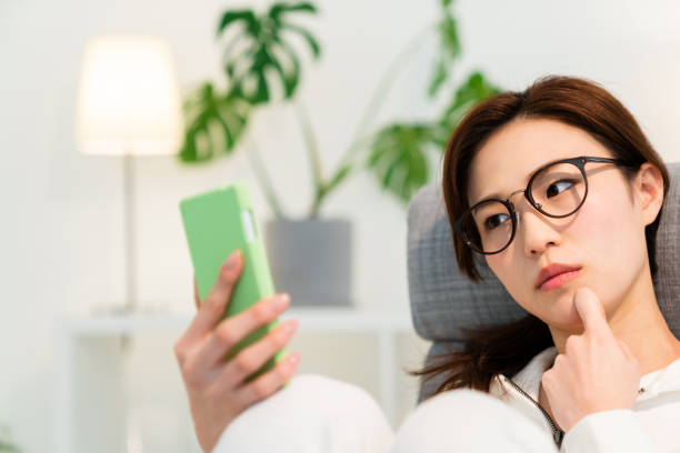 istock asian woman to see a smart phone,think, 1250360583