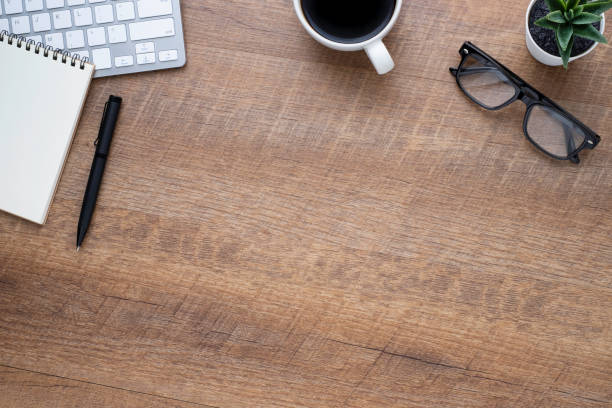 istock Wood office desk table with keyboard, notebook and coffee cup with equipment other office supplies. Business and finance concept. Flat lay with blank copy space, top view. 1250361230
