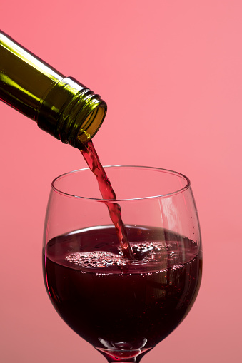 Turning wine into bowl with pink background