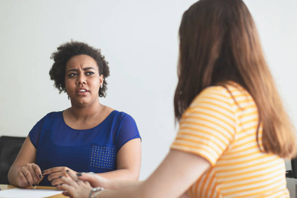 istock Two young women talking in an office. 1250368545