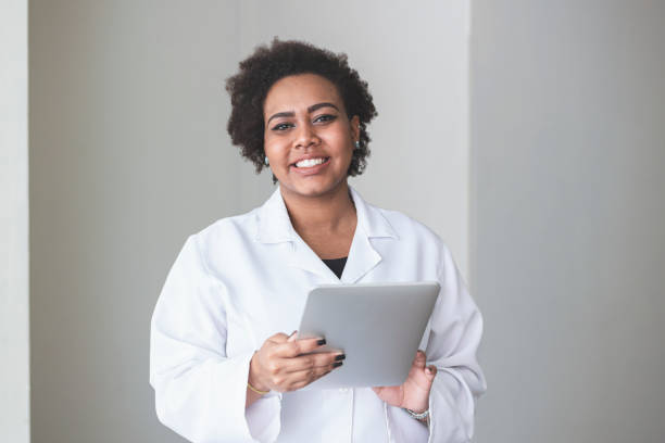 istock Doctor holding a digital tablet and smiling. 1250368802
