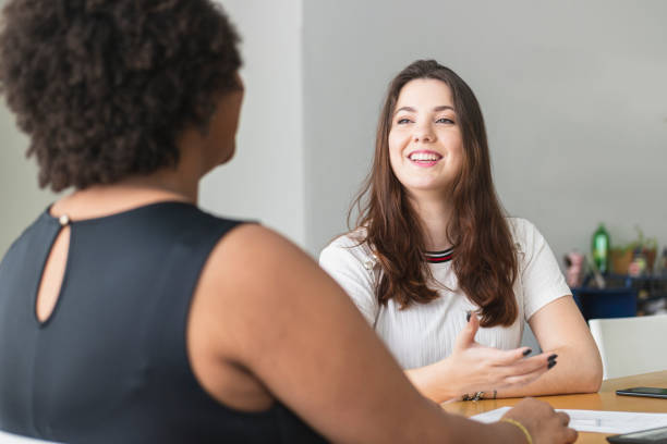 istock Two young women talking in an office. 1250368806