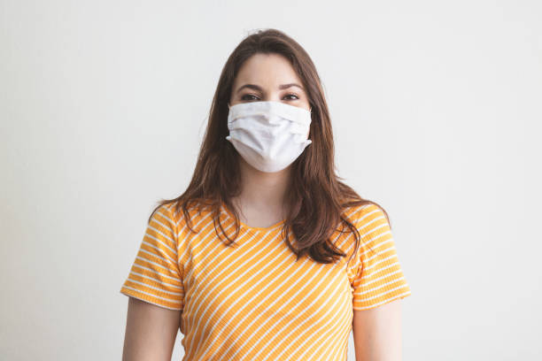 istock Young woman wearing a protective mask smiling. 1250369991