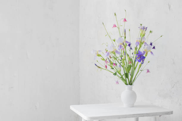 istock flowers in white vase in white vintage interior 1250371342
