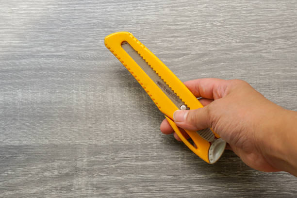 istock close up people use yellow cutter in for cutting 1250372231