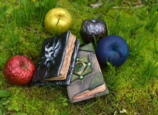 istock Fairy tale books with magic poisonous apples in the garden. 1250376555