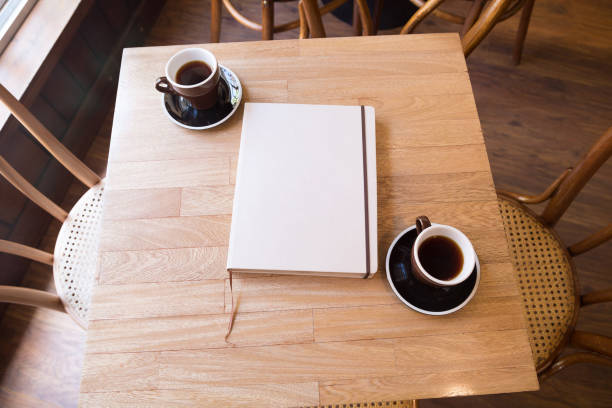 istock A book with an empty cover and two coffees on the table 1250378082
