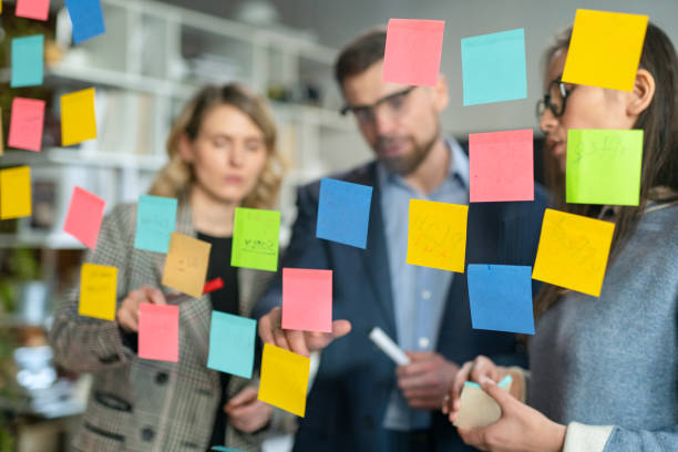 istock Creative Business Team Brainstorming Ideas Working Together Near Glass Wall With Sticky Notes. Colleagues approve. Business Success Concept 1250378213