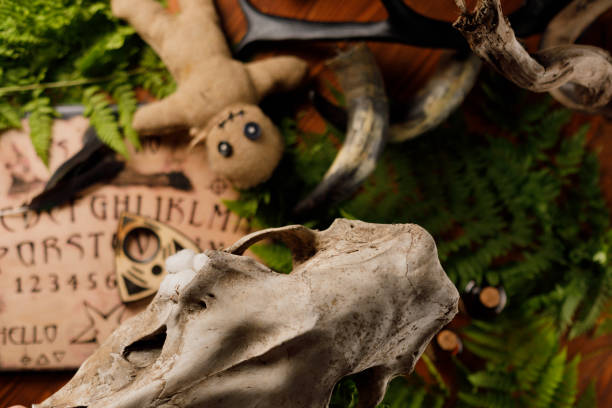istock Mystic ritual with Ouija and candles. Devil's board concept, black magic or fortune telling rite with occult and esoteric symbols. 1250385935