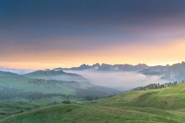 Green sunrise morning foggy day natural condition toned over Ortisei St Ulrich Urtijei village, Dolomites Alps mountains, Trentino Alto Adige Sud Tyrol, Italy, Europe beautiful scenics background