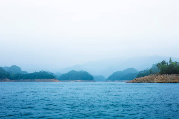 Sau Reservoir between Guilleries mountain range - Catalonia landscape, Summer morning, with the ancient church belltower in the middle of the water reservoir. 