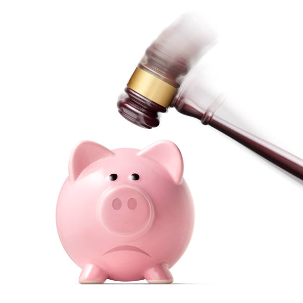 The cost of justice. Broken piggy bank by judge gavel. Broken piggy bank by judge gavel isolated on white background. costus stock pictures, royalty-free photos & images