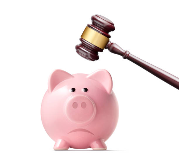 The cost of justice. Broken piggy bank by judge gavel. Broken piggy bank by judge gavel isolated on white background. costus stock pictures, royalty-free photos & images