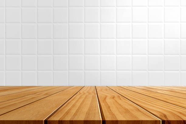 istock Wooden tabletop template mockup for display merchandise. wooden shelf table isolated on white ceramic tile background. 1250392081