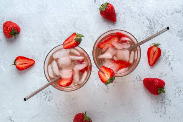 istock Two strawberry cocktails with ice on a light background with berries 1250393369