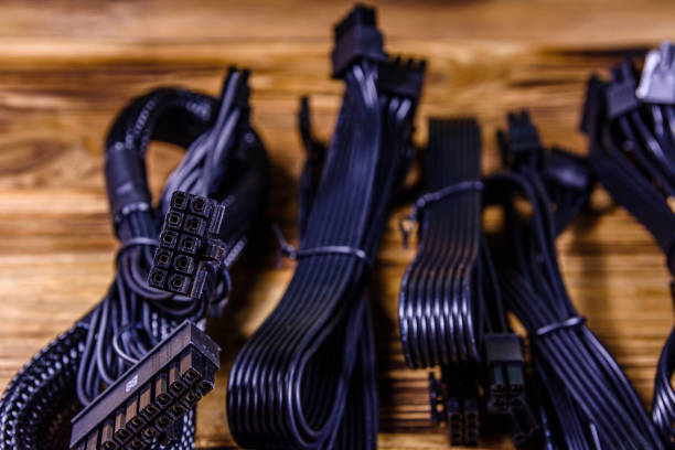 istock Set of computer psu cables on a wooden background 1250394119
