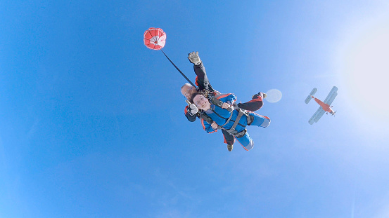 Woman with instructor in free fall.