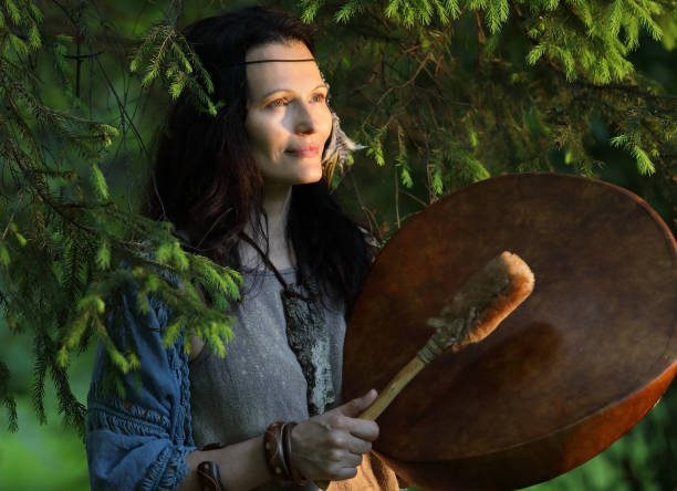 istock Shaman woman in the forest drumming 1250396420