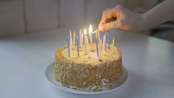 istock Lighting the candles on birthday cake 1250398108