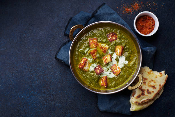 Vegetarian palak paneer Flat lay top view of vegetarian palak paneer starter. Indian cuisine, curry dish with soft cheese and spinach on concrete background with copy space indian food stock pictures, royalty-free photos & images