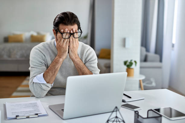 istock Tired male entrepreneur working on a computer at home. 1250400614