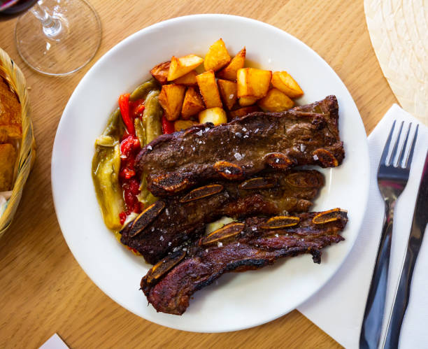 istock Grilled beef ribs with fried potatoes and pepper 1250404048