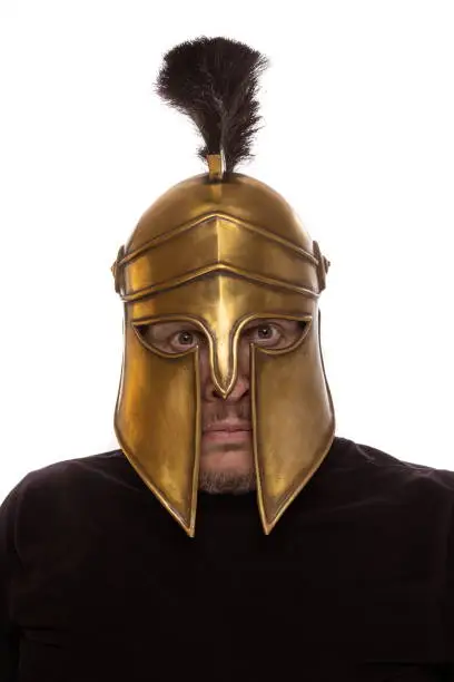 Man in historical copy helmet Spartan warrior on a white background