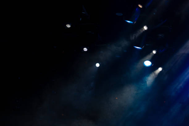 istock lights spotlights and smoke over the stage 1250405778
