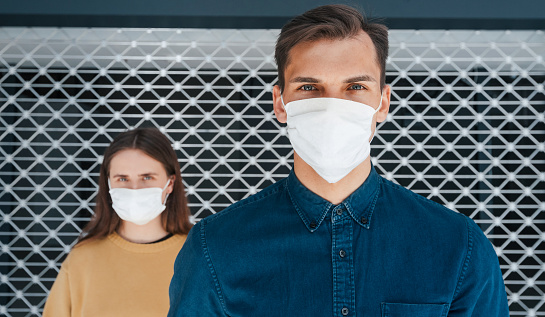 close up. a man and a woman in protective masks standing next to each other . the concept of health