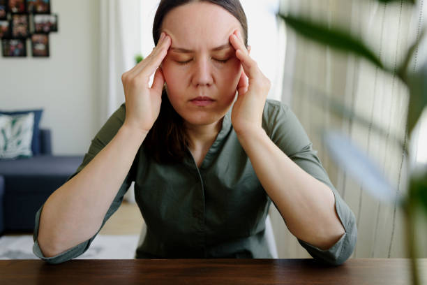 istock Woman thinking. Holding hands on her head. Tired, stress 1250412537