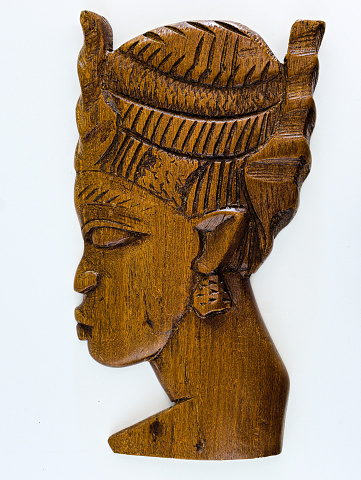 a woman's head as traditional carving from wood