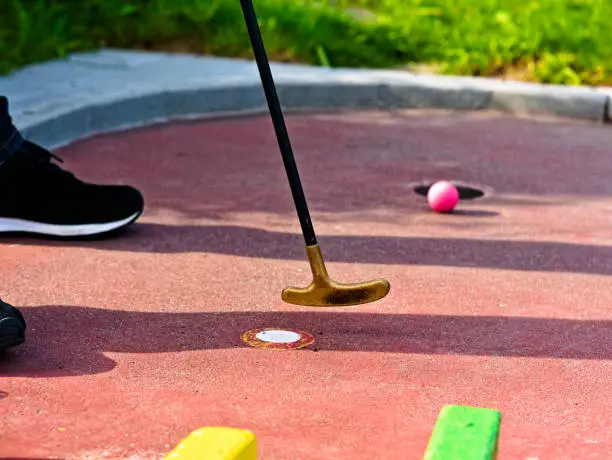 an attempt to sink the ball in the hole during mini golf