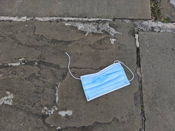 istock A broken, used face mask dropped on the floor 1250417707