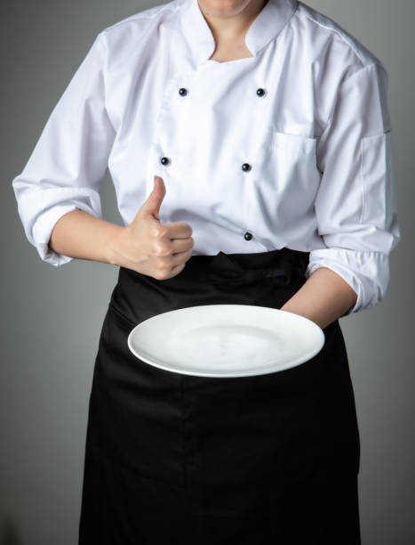 istock chef uniform with white empty plate welcome present dish restaurant promotion 1250418265