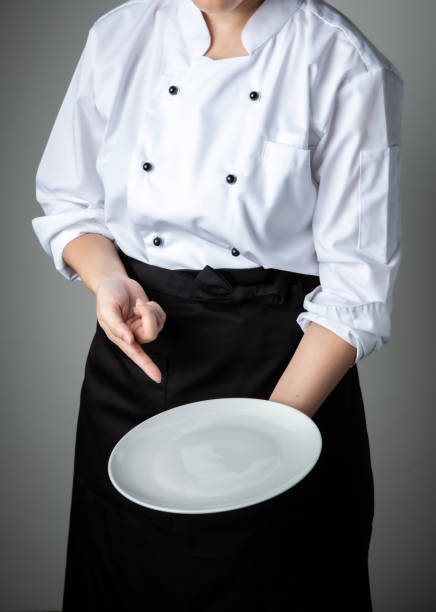 istock chef uniform with white empty plate welcome present dish restaurant promotion 1250418297