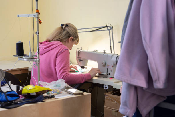 istock Girl sews on a professional sewing machine in the workshop 1250418953