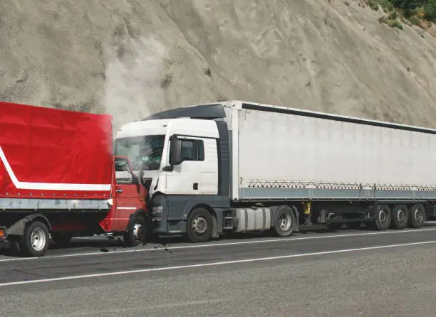 Photo of Road accident. Two trucks collided head-on.