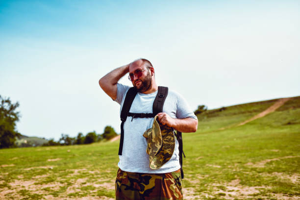 istock Balding Male Taking Off Hat To Cool Head During Hiking On Mountain 1250423554