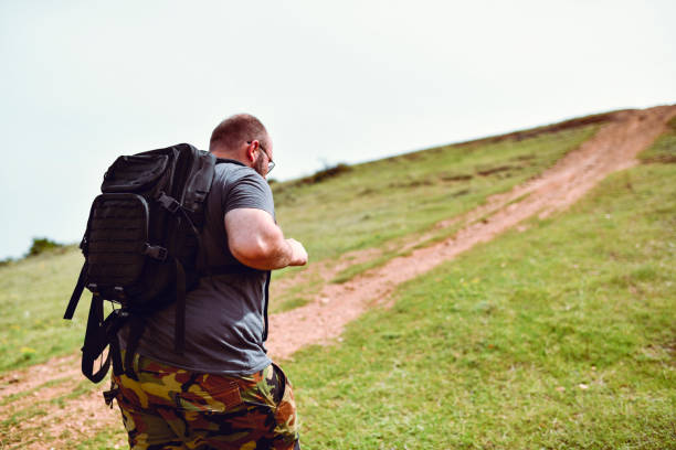 Balding Male Walking Uphill During Hiking Trip